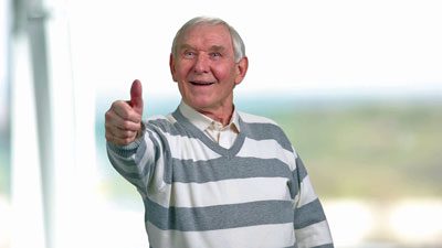 elderly man giving thumbs up